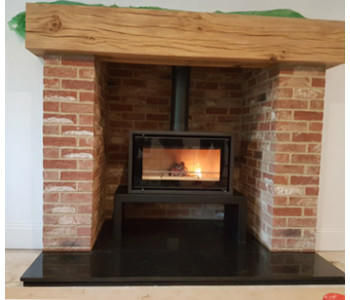 Stovax Studio 1 Freestanding Woodburner - on bench installed to pumice lined chimney, polished granite hearths, brick pillars and locally sourced oak beam near Weybridge, Surrey